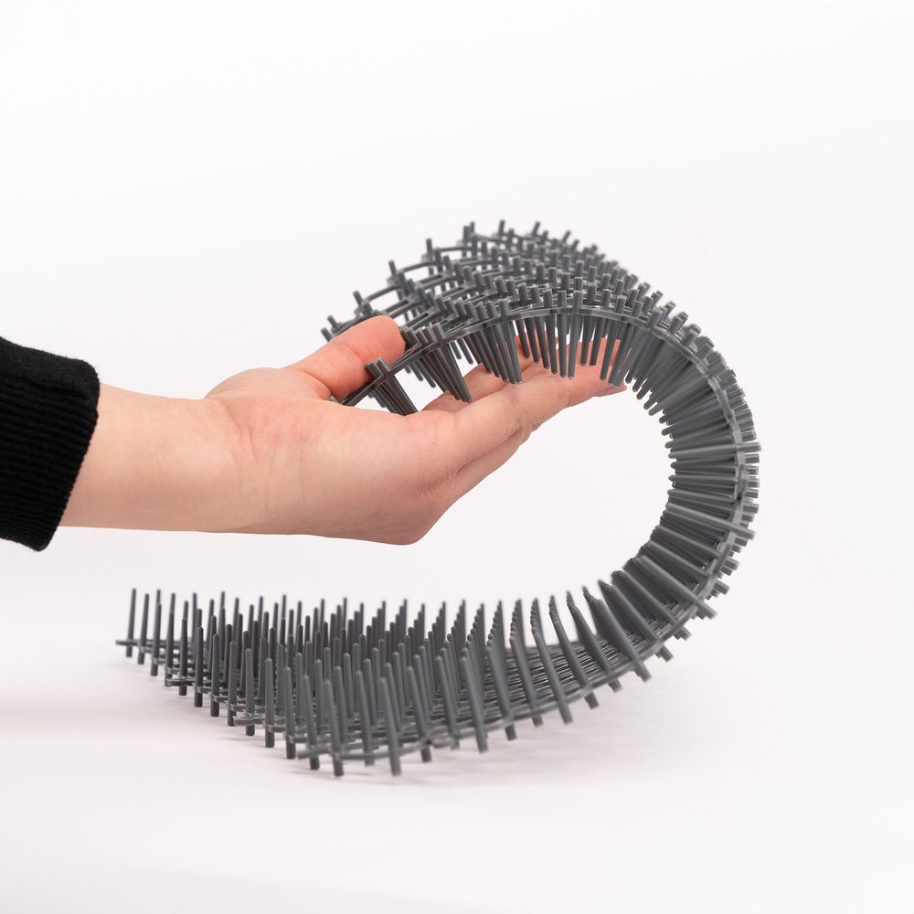 Hand bending a flexible Petfolio spike mat